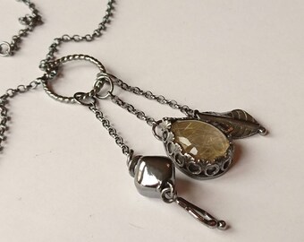 Sterling silver handmade golden rutilated quartz necklace with leaf charms, oxidised. Hallmarked in Edinburgh.
