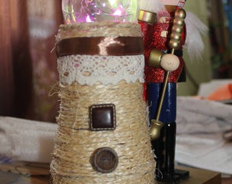 Vase decorated with rope multicolor light bulb