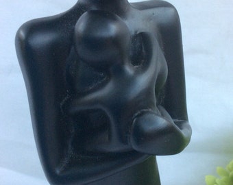 Vintage mother and child black resin figure.