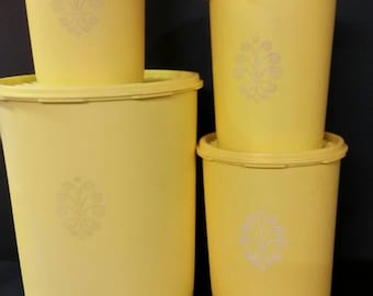 Vintage tupperware yellow canisters with lids. Set of 4