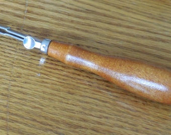 Vintage tracing wheel sewing tool with wooden handle