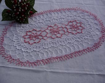 Oval napkin is hand crocheted cotton white and pink shades.