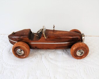 Wooden and silver toy car.
