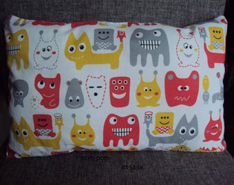 small rectangular cushion 33 x 22 theme monsters color red, mustard yellow, gray on white background
