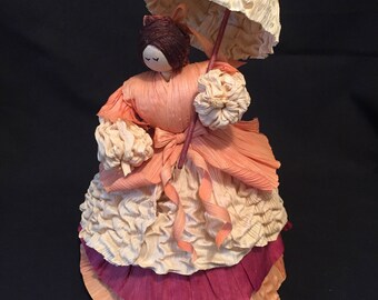 Cornhusk southern Belle in peach and burgundy.