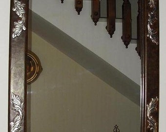 Embossed leather and recamado in silver mirror.