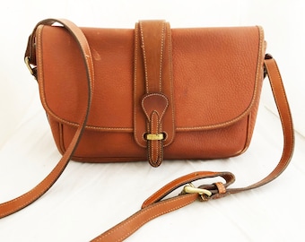 Dooney and Bourke - Leather Medium All weather leather British tan purse with adjustable shoulder strap