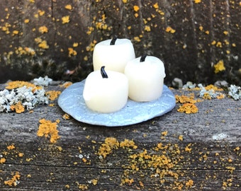 Three white candles on silver tray made of polymer clay