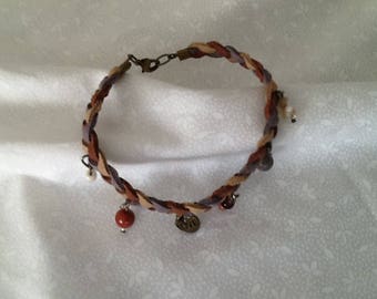 A faux suede braided and beaded bracelet