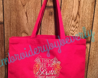 They see me sewin they hatin red canvas tote bag. Take it to your sewing, quilting, crafting classes.