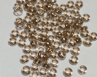 6 grams 8/0 #989 Demi Round Toho seed bead, bronze lined crystal