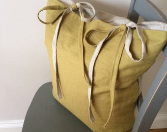 Olive and natural linen cushion with ties.