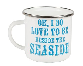 Enamel mug next to the edge of sea - Beside the Seaside