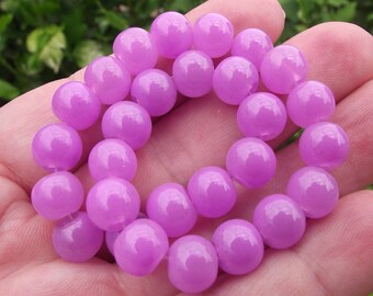 10 pearls 8 MM round purple glass.