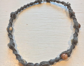 Grey hemp necklace with brown, grey, and cream colored stone beads