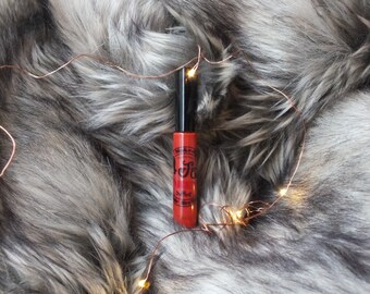 Jeni Retro's WICKED PUMPKIN, liquid lipstick that goes on wet and dries matte.