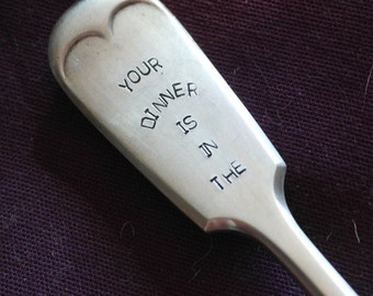 hand samped cutlery fork your dinner is in the dog