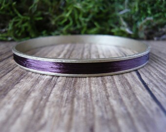 Bangle is solid brass and silk plant