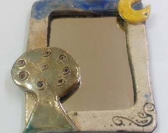 Ceramic raku mirror with tree.