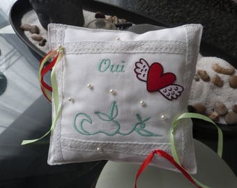 A "Yes" in white linen wedding ring cushion