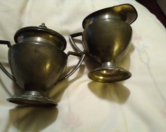Pewter lidded sugar and creamer. Stamped on bottom
