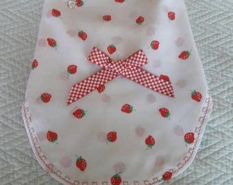 White dress with printed red strawberries.