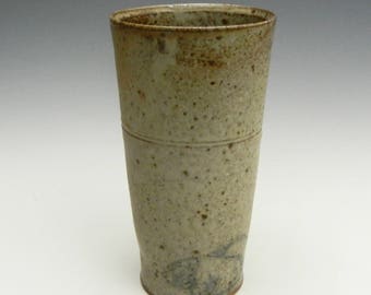 Wood fired cup with ash glaze and pigs