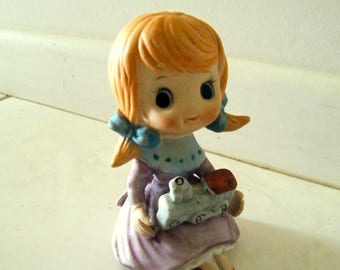 Vintage 1980's unglazed porcelain little red haired girl holding train ornament