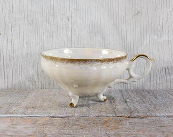 Vintage footed teacup without matching saucer, pearlescent, gold detailing, floral pattern inside cup