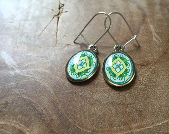 Mandala dangeling earrings: white, green, orange red. Oval.