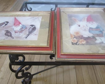 A pair of gnomes one with birds the other with a rabbit