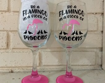 Be a flamingo in a field of pigeons hand painted wine glass
