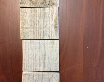 Four rustic pieces of sanded wood for projects