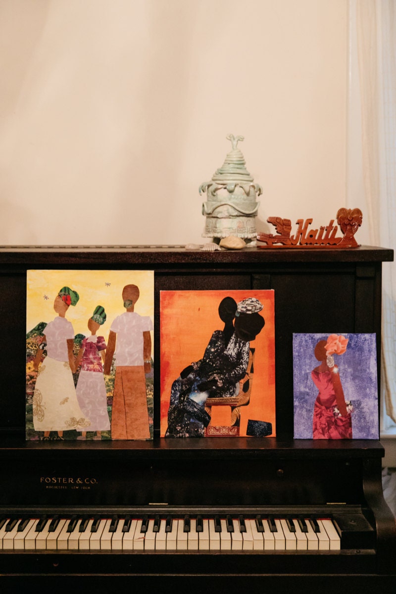 Three collages arranged on a piano in Mirlande's home.