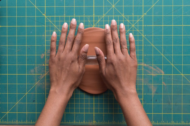 Image of hands rolling clay. Image of hands rolling clay.