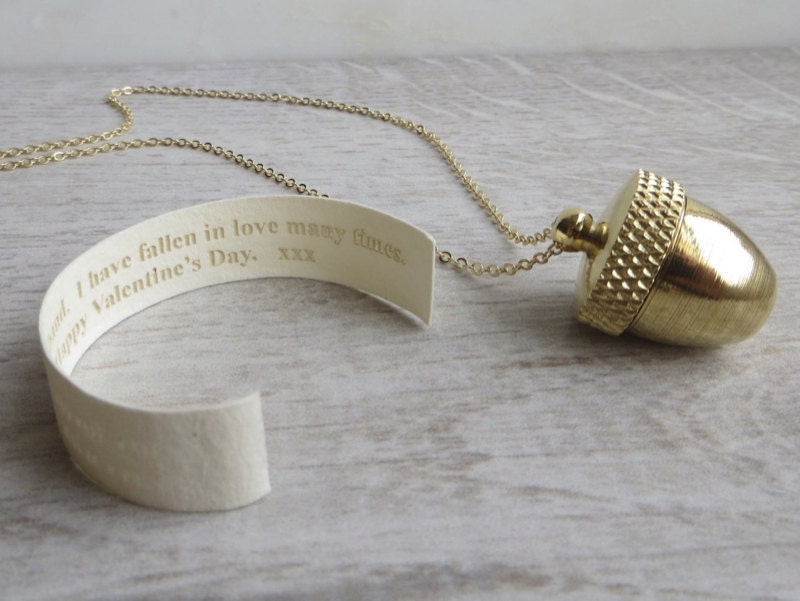 A brass acorn locket necklace.