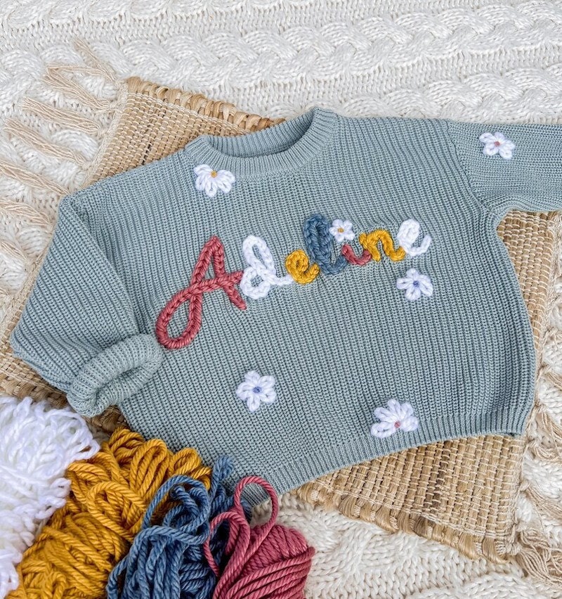 Personalized hand-embroidered baby sweater from Etsy.