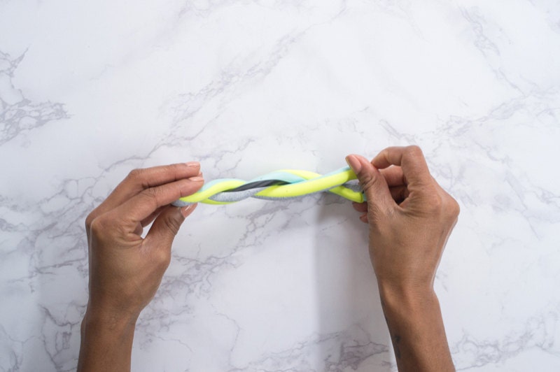 Hands twisting the folded strand. Hands twisting the folded strand.