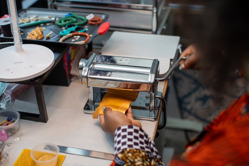 Dorianne from Atiwo Designs making jewelry in her studio.