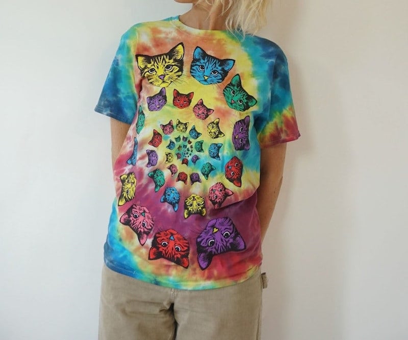 Person wearing a vintage tie-dye colorful t-shirt with cats on it