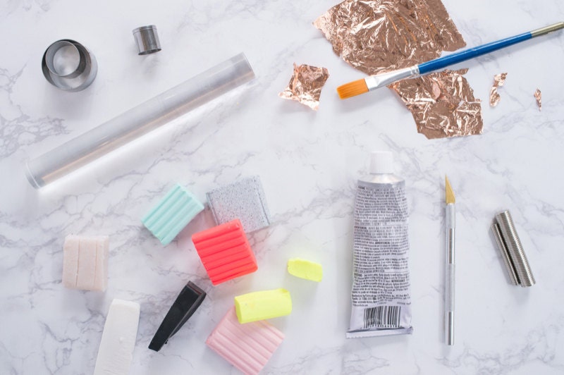 A flat-lay of materials needed to make DIY galaxy magnets. A flat-lay of materials needed to make DIY galaxy magnets.