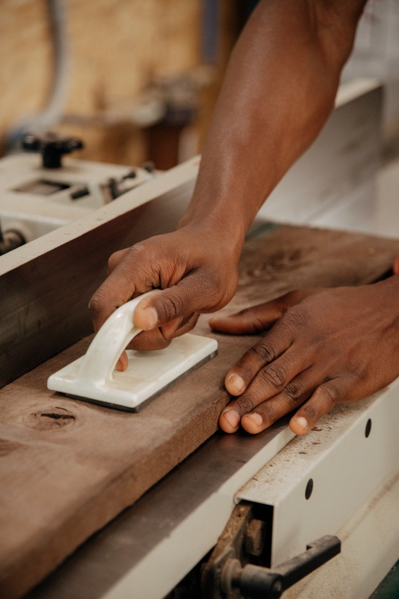 Close-up photos of hands sanding wood