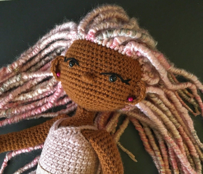 A crochet doll from A Touch of Blu Designs, a Black-owned business on Etsy.