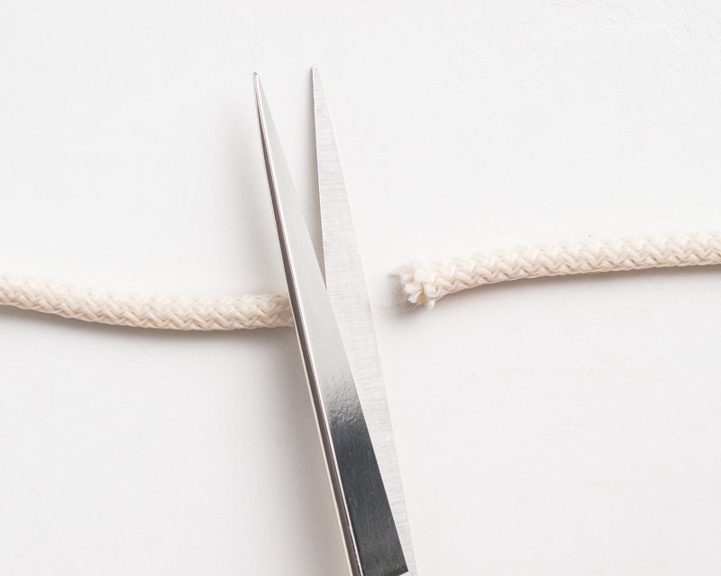 Scissors cutting rope. Scissors cutting rope.