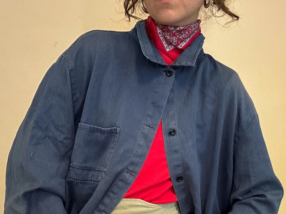 A woman wearing a vintage workwear jacket from Etsy.