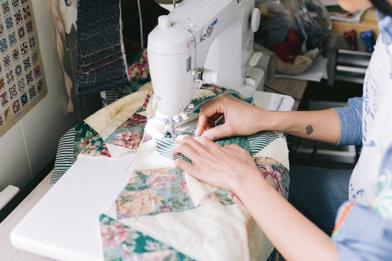 Deedee sewing in her studio.