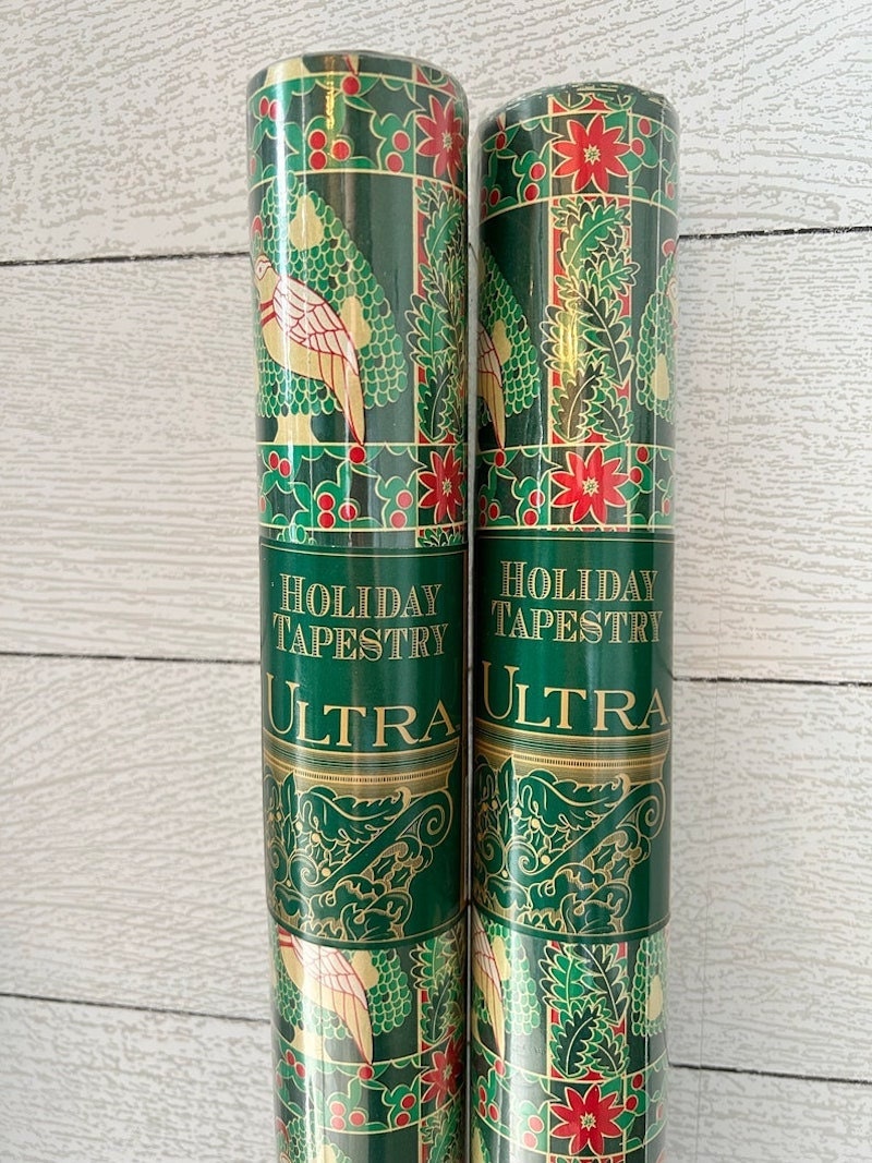 Two rolls of vintage Christmas wrapping paper.