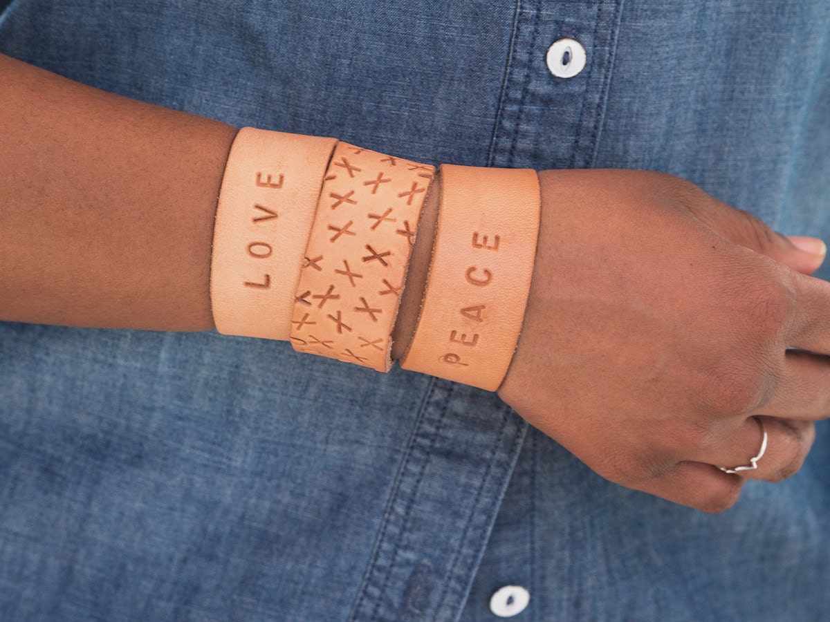 A woman models DIY leather cuff bracelets