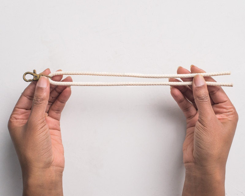 Hands holding rope with a clasp. Hands holding rope with a clasp.
