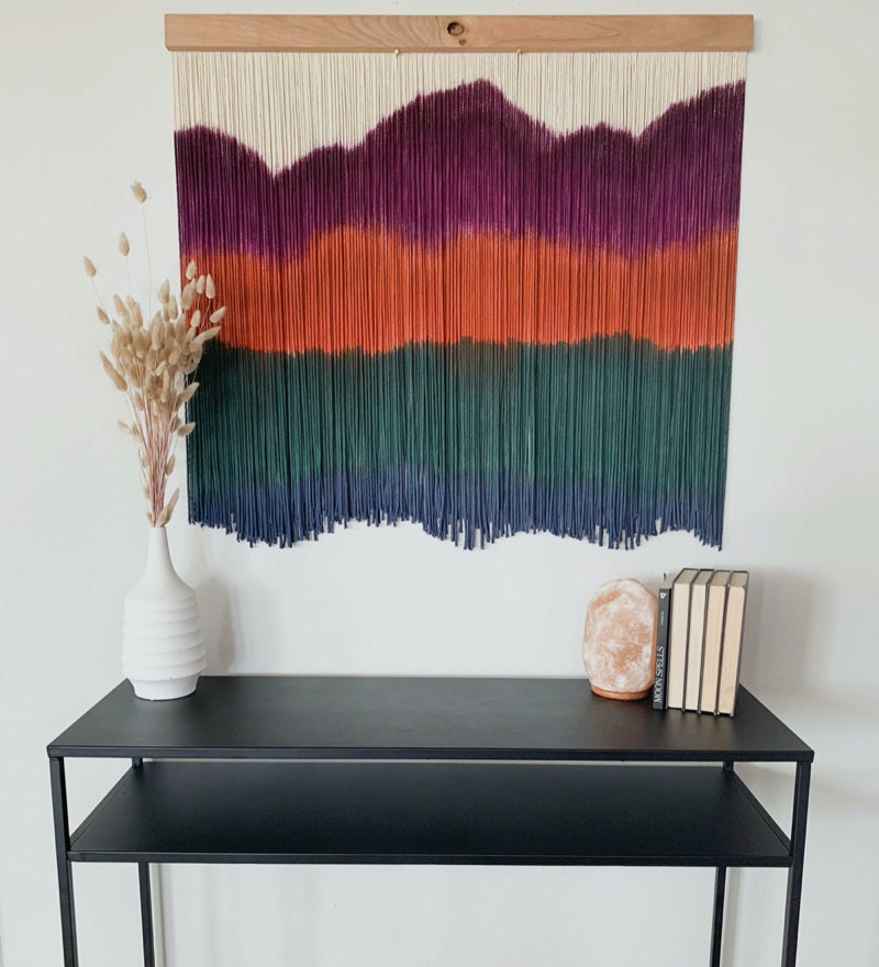 A dip-dyed fiber art wall hanging from J. Durán Art + Home, a Black-owned business on Etsy.